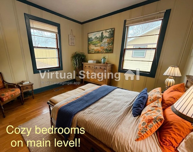 bedroom featuring crown molding and hardwood / wood-style floors