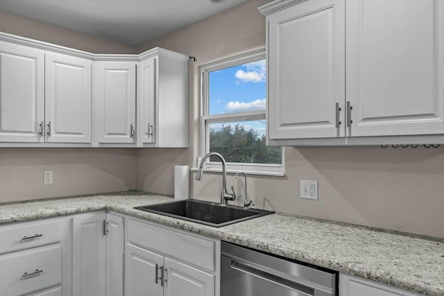 kitchen featuring sink, stainless steel dishwasher, and white cabinets