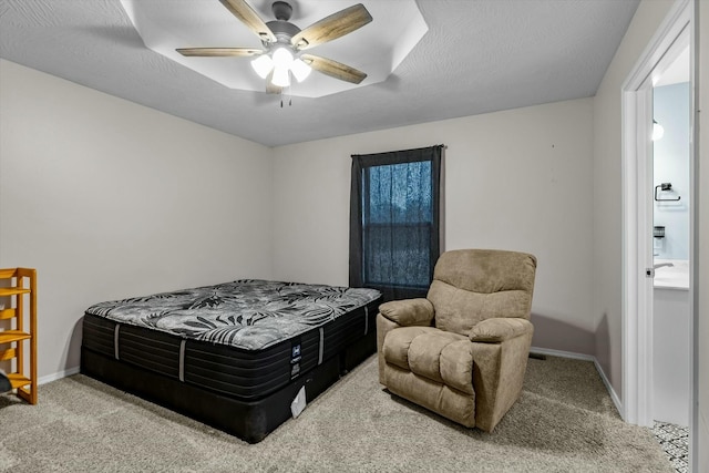 carpeted bedroom featuring ceiling fan and a textured ceiling