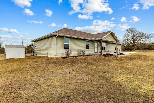 exterior space featuring a yard and a storage unit