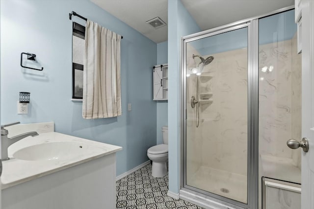 bathroom with vanity, toilet, a shower with shower door, and tile patterned flooring