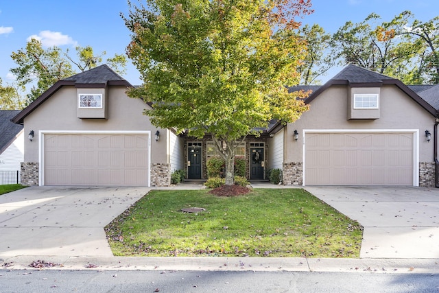 view of property with a garage and a front lawn