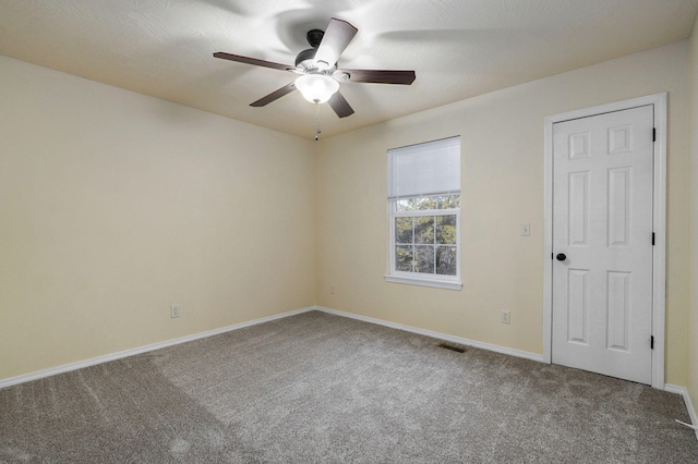 spare room with ceiling fan and carpet floors