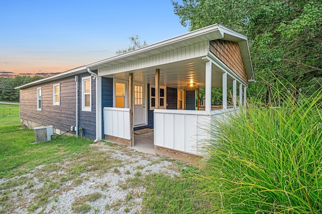 property exterior at dusk featuring cooling unit