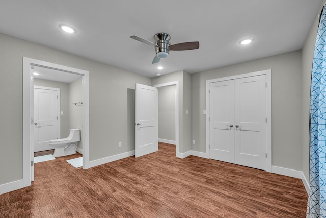 unfurnished bedroom featuring hardwood / wood-style flooring, ceiling fan, and a closet