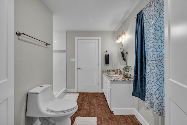 bathroom with vanity, hardwood / wood-style flooring, and toilet