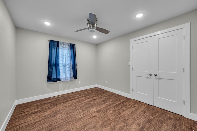 unfurnished bedroom with ceiling fan, hardwood / wood-style floors, and a closet