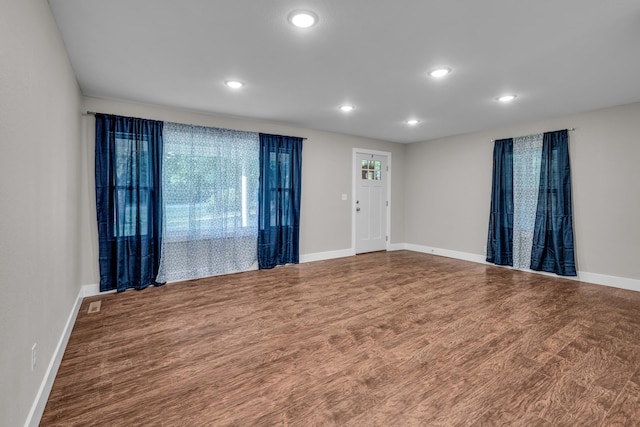 unfurnished room featuring hardwood / wood-style flooring