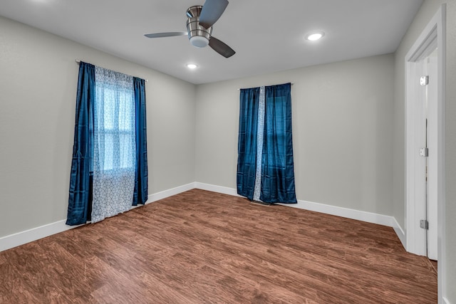 empty room with ceiling fan and hardwood / wood-style floors