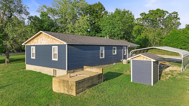 back of property featuring a carport and a yard