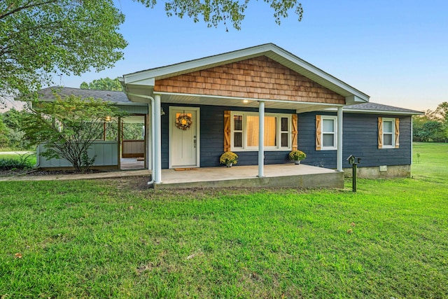 back of property featuring a yard and covered porch