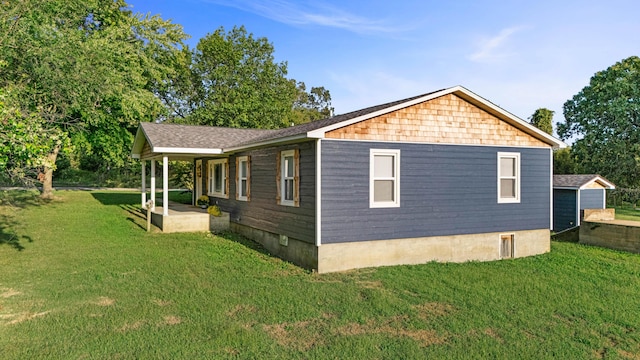 view of side of home with a yard