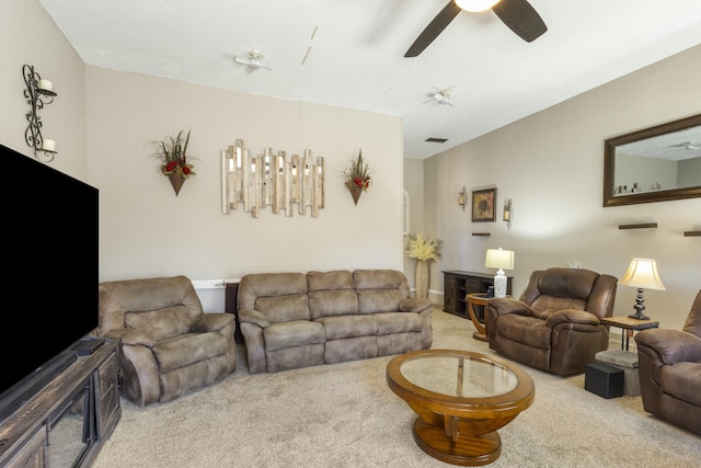 living room featuring carpet, visible vents, and ceiling fan