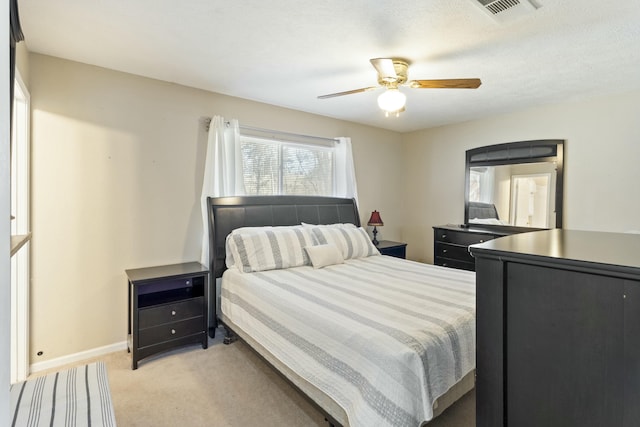 bedroom featuring light carpet, baseboards, visible vents, and ceiling fan