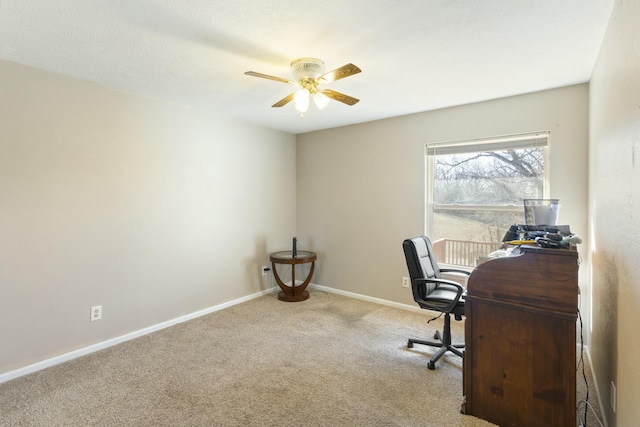 office space with ceiling fan, carpet floors, and baseboards