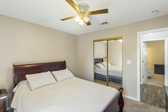 bedroom featuring carpet floors, a closet, visible vents, ceiling fan, and baseboards