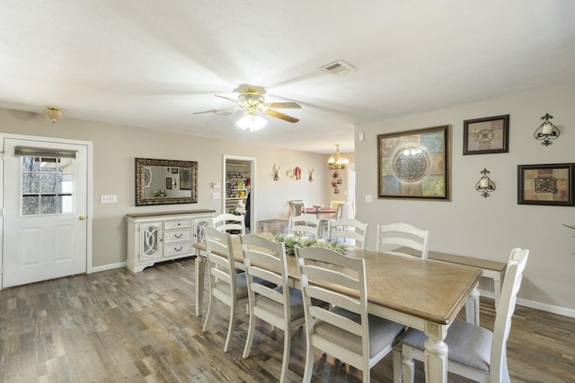 dining space with visible vents, baseboards, and wood finished floors