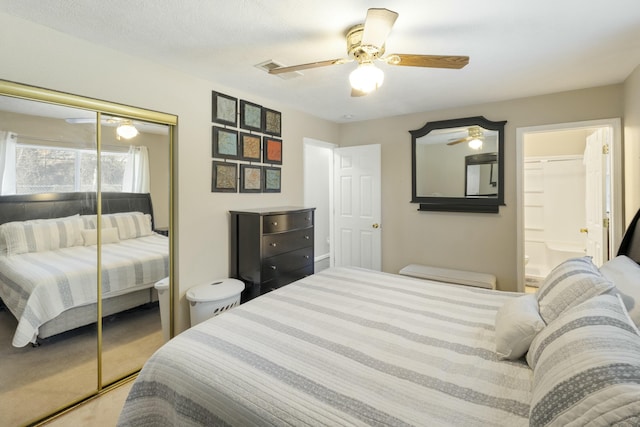 bedroom with connected bathroom, a closet, carpet flooring, and ceiling fan