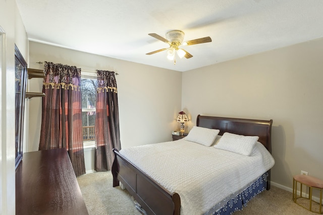 bedroom with light colored carpet, ceiling fan, and baseboards