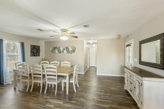 dining area featuring dark wood-style floors, visible vents, baseboards, and a ceiling fan