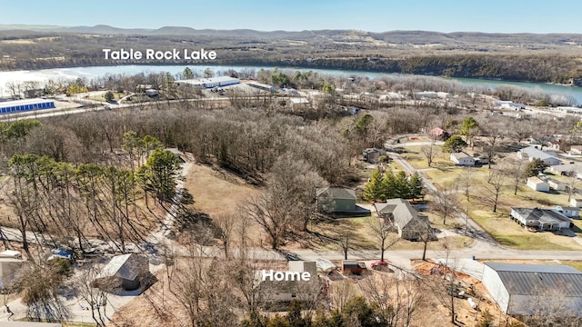 drone / aerial view featuring a water and mountain view