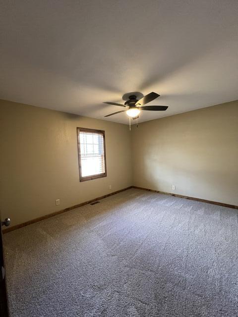 carpeted empty room with ceiling fan