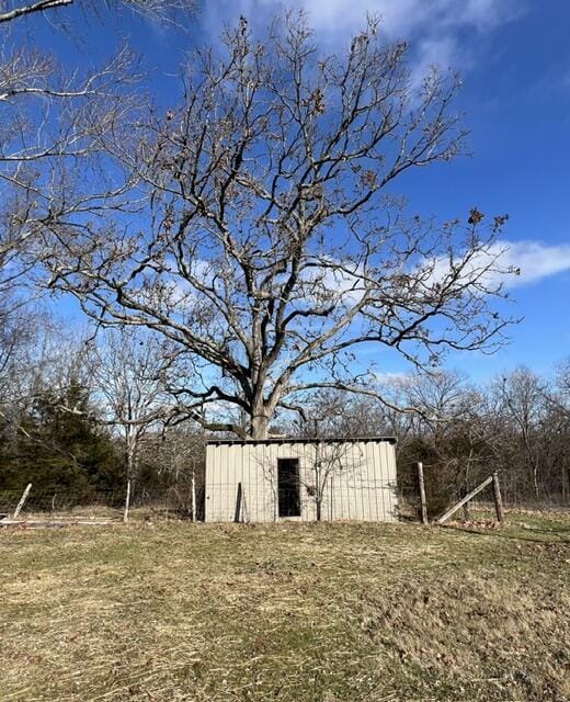 view of outbuilding featuring a lawn