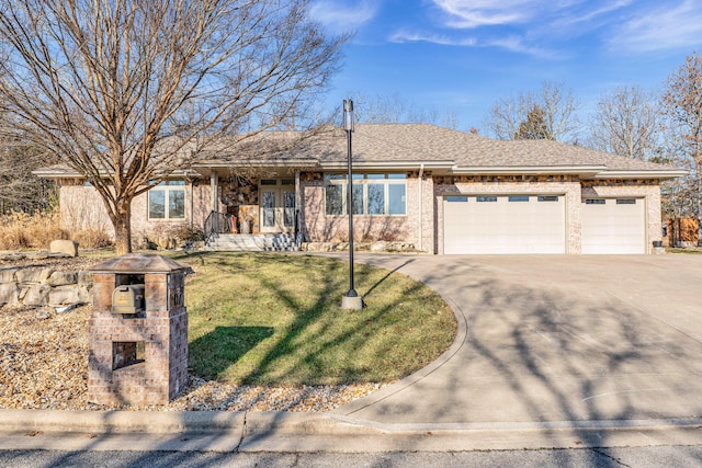 ranch-style home featuring a garage and a front lawn