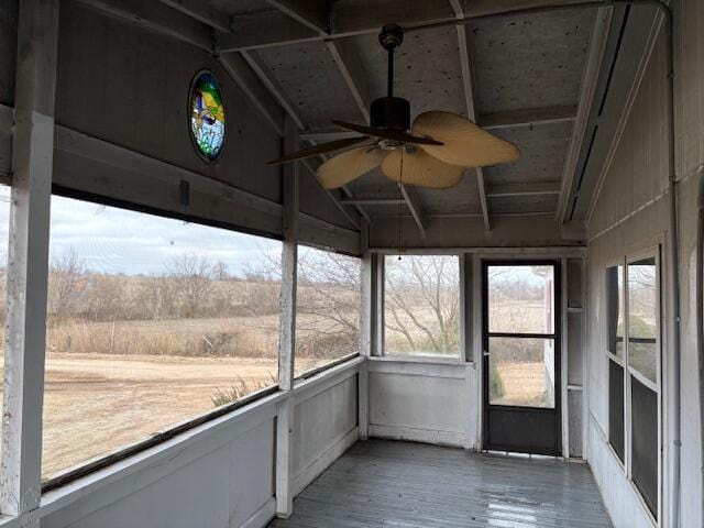 unfurnished sunroom with vaulted ceiling and ceiling fan