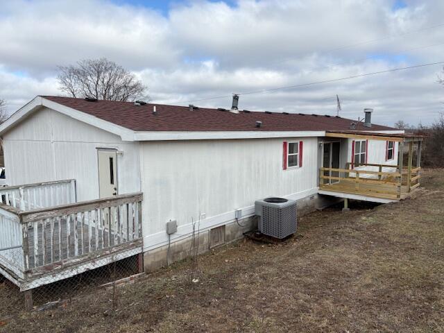 back of house with a wooden deck and cooling unit