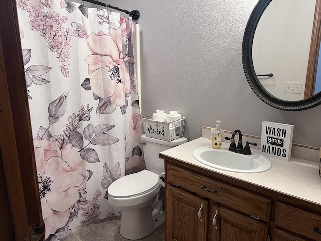 bathroom featuring vanity, a shower with curtain, and toilet