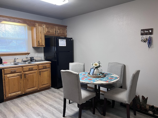 dining space featuring sink and light hardwood / wood-style flooring