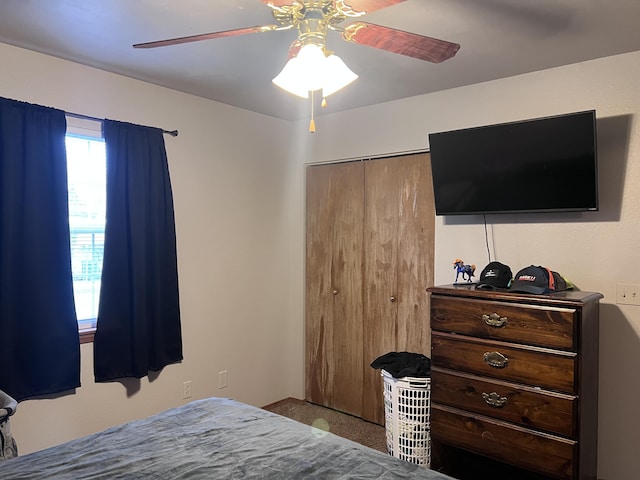 bedroom with light colored carpet, a closet, and ceiling fan