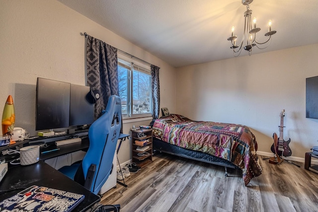 bedroom with wood-type flooring and a chandelier