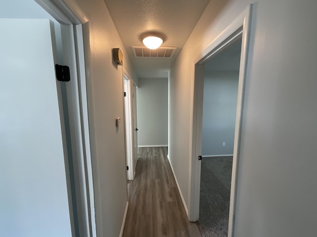 hallway with dark hardwood / wood-style flooring