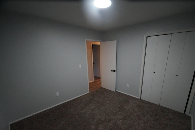 unfurnished bedroom featuring carpet flooring and a closet