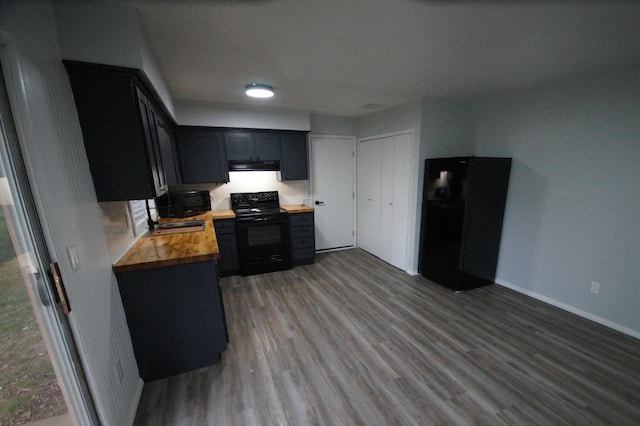 kitchen featuring butcher block counters, sink, hardwood / wood-style flooring, and black appliances