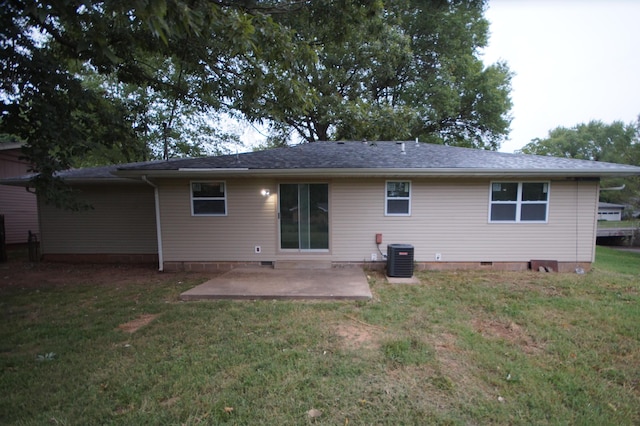 back of property with a yard, central air condition unit, and a patio area