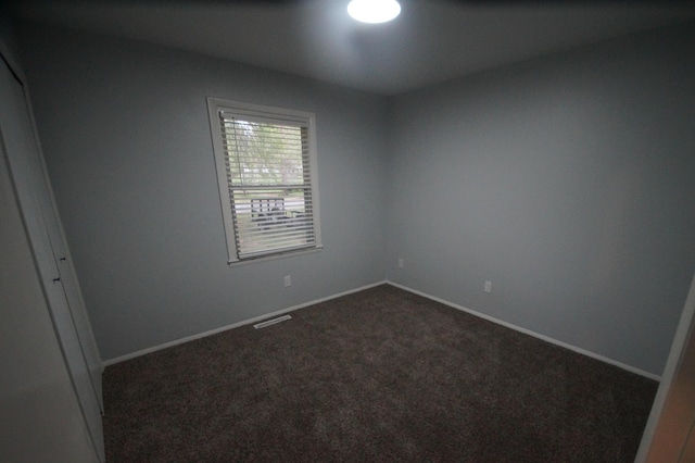 empty room with dark carpet