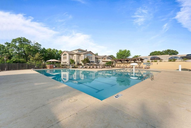 pool featuring a patio area and fence