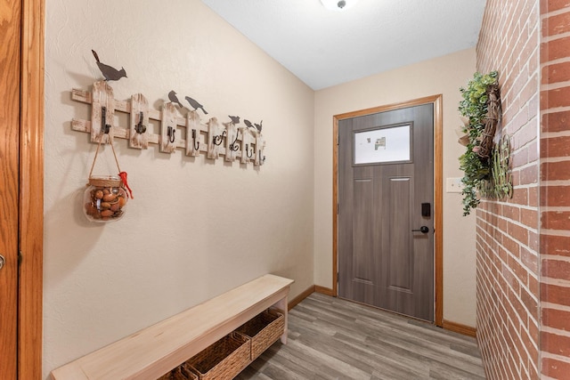 interior space with baseboards and wood finished floors