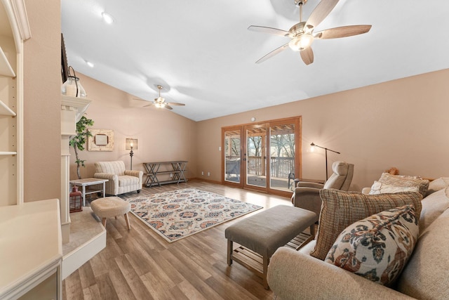 living room with hardwood / wood-style flooring, vaulted ceiling, and ceiling fan