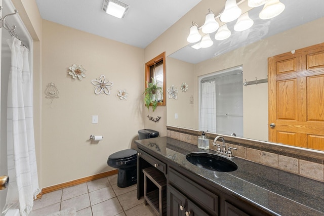 bathroom featuring backsplash, toilet, vanity, baseboards, and tile patterned floors