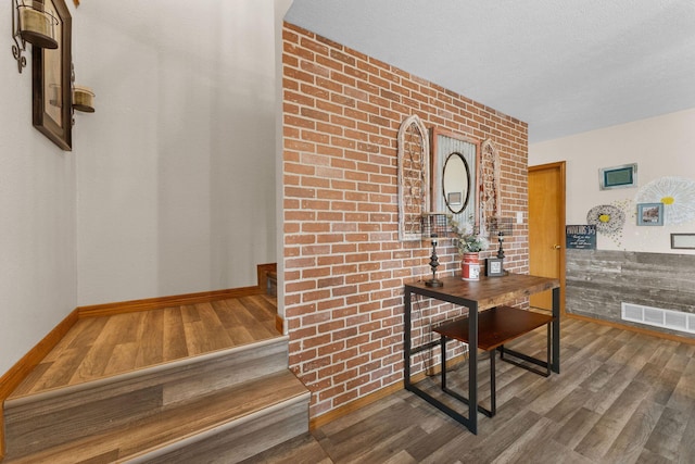 hallway featuring hardwood / wood-style flooring and a textured ceiling