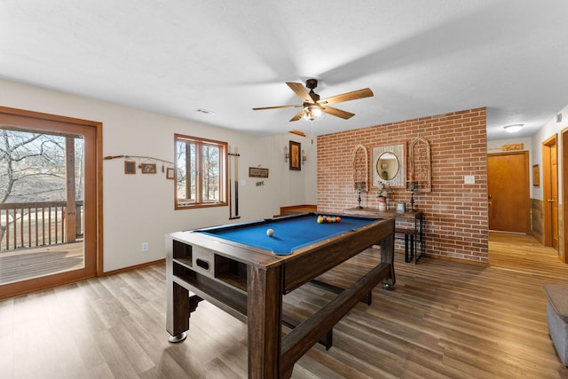 recreation room with ceiling fan, billiards, brick wall, and hardwood / wood-style floors