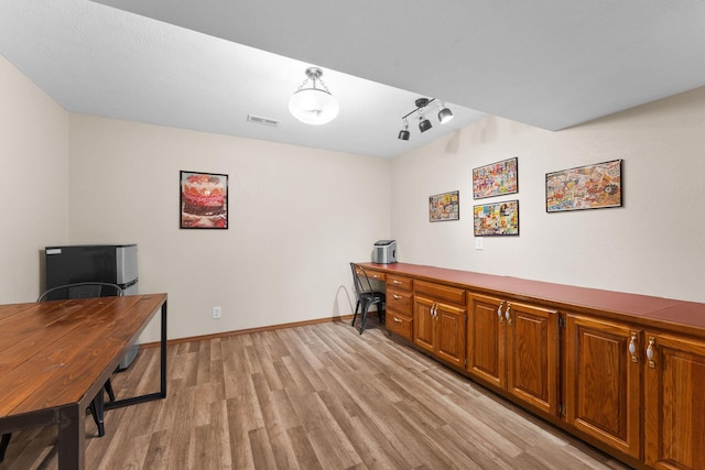 office space featuring light wood-style floors, visible vents, and baseboards