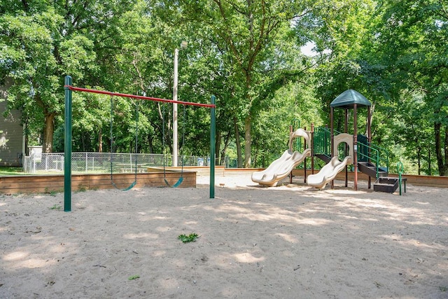 community jungle gym featuring fence