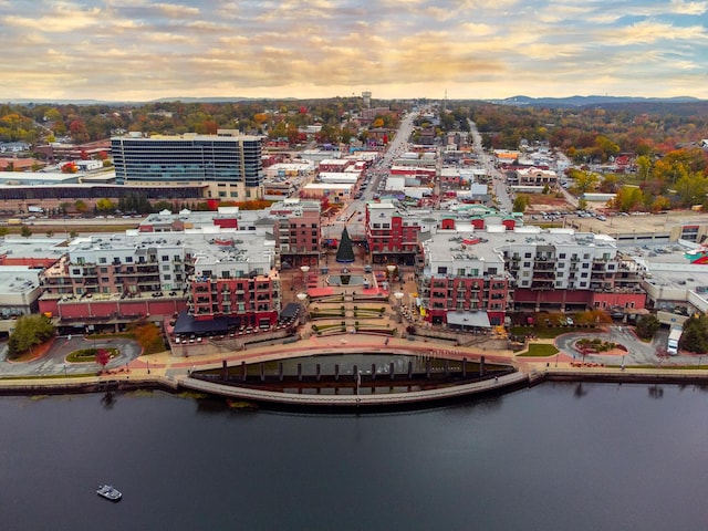 aerial view at dusk with a water view and a city view