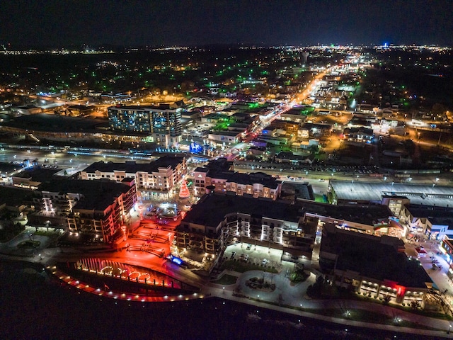 aerial view at night featuring a view of city lights