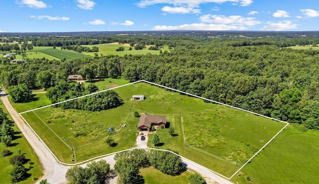 birds eye view of property with a rural view